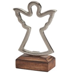 A stunning silver metal angel silhouette on a wooden base.