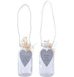 An assortment of 2 mini glass bottles, each with a sentimental quote on a heart shaped tag, with raffia tie. 