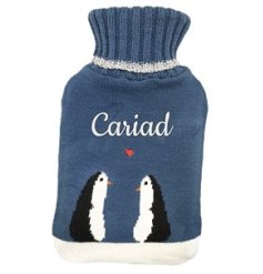 A cute hot water bottle/cover with sweet penguin design and "love"written in Welsh with heart detail. 