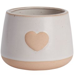 A stylish round planter with a stoneware heart detail. A beautifully glazed natural product for your houseplants. 