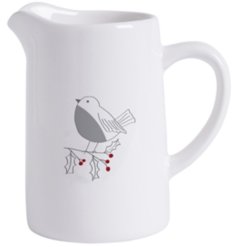 A small ceramic jug featuring a simple robin and holly design. 