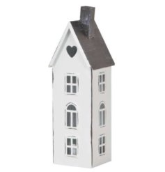A distressed finish white metal house shaped lantern with grey roof, and cut out heart and windows details. 