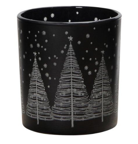 A festive tea light holder with a black background and silver tree and snowflake design. 