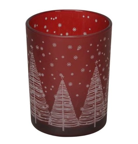 A deep red glass tea light holder with festive silver tree and snowflake design. 