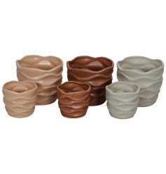 A set of 2 dolomite plant pots in an assortment of 3 colours, each with a rippled 3D design. 