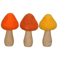 An assortment of 3 brightly coloured mushroom decorations, each with a textured fabric top design. 