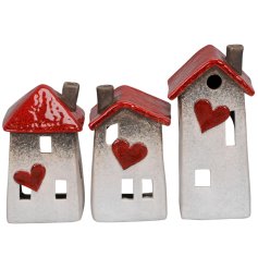 3 Assorted house shaped lanterns featuring a crooked design, cut out windows and red details including heart motif. 
