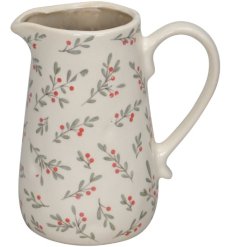 A cream ceramic jug with a pretty red berry and foliage print design.