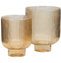 A set of two peach coloured glass lanterns, each with a striped ribbed design.