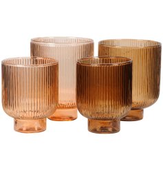 A set of two glass lanterns featuring a ribbed stripe design in a warm bronze colours. 