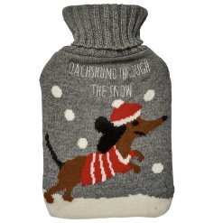 A cute grey hot water bottle/ cover with dachshund motif and snow scene. 