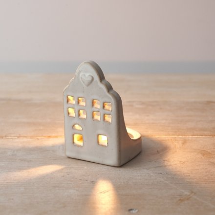 A rustic ceramic t-light holder with a natural glaze and dainty heart detail.