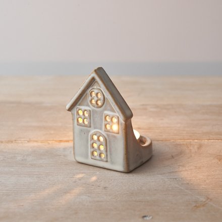 A rough luxe ceramic t-light holder with house design. A chic interior accessory for the home this season.