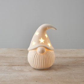 A chic ceramic Santa ornament with stars and a warm glow LED light. 