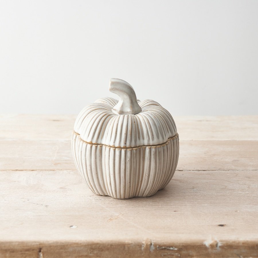 A natural ceramic pumpkin container with a cream washed glaze. A stylish interior item for the home and kitchen. 