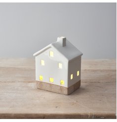 A rustic ceramic house with warm glow LED lights. An on trend and super stylish interior accessory. 