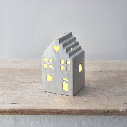 A rough luxe ceramic house complete with an led t-light. 
