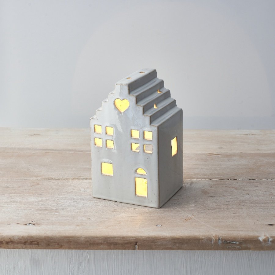 A stylish ceramic t-light house with heritage details and a heart motif. A rustic, on trend interior item for the home. 