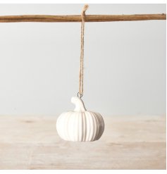 A charming pumpkin decoration with a white finish and jute string hanger. 