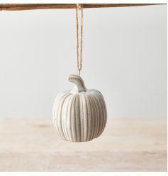 A rustic pumpkin ornament with a natural glaze and jute string hanger. 