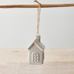 A chic ceramic house ornament with a natural glaze. Complete with jute string hanger.