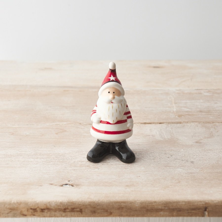 A cute and characterful red and white Santa ornament with star hat and stripy jumper 