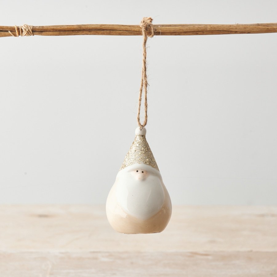 A sparkling ceramic gonk ornament in neutral colours with a gold glitter hat. Complete with rustic jute string hanger. 