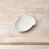 A chic ceramic acorn dish in a natural hue with a rustic finish and speckled detailing. 