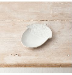 A chic ceramic acorn dish in a natural hue with a rustic finish and speckled detailing. 