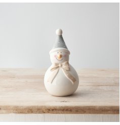 A sweet snowman ornament with a long polkadot bow scarf and hat. 
