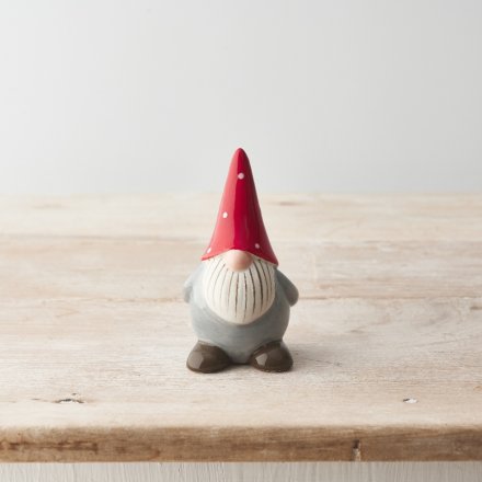 A charming ceramic gonk ornament with a red and white polka dot hat and detailed beard. 