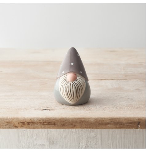 A ceramic gonk ornament in grey and white colours. Beautifully detailed with a painterly beard and a polka dot hat. 