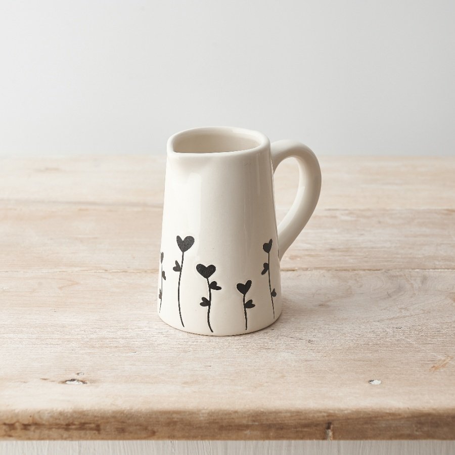 A charming jug with a dainty floral heart design cascading around the sides. 