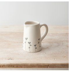 A rustic jug with a grey floral and heart design. A must have seasonal item for the home and kitchen. 