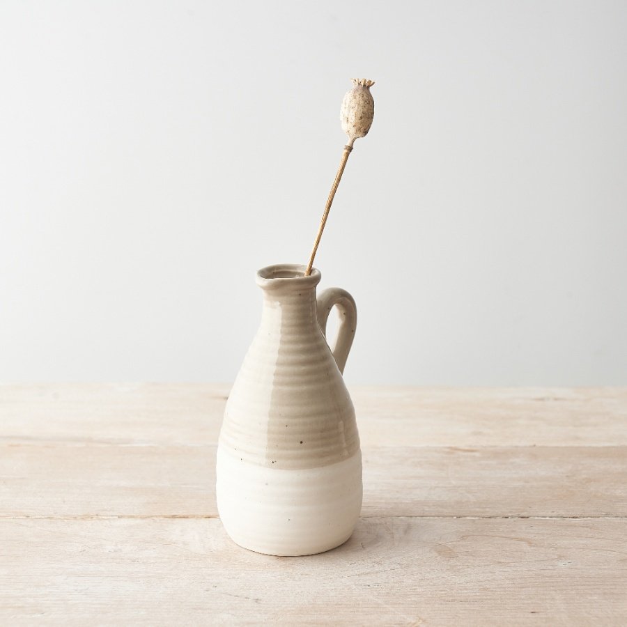 A chic ceramic jug with a natural glaze and two-tone finish. 