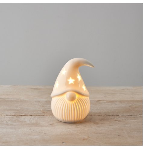 A chic white ceramic gonk with star cut out details and warm glow led lights. 