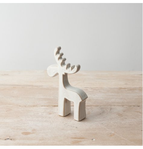 A rustic and contemporary ceramic reindeer ornament with a natural finish. 