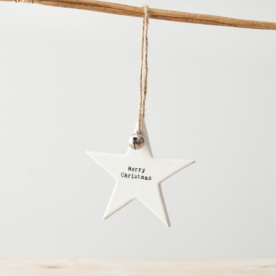 A stunning white ceramic star with a Merry Christmas stamped slogan and silver jingle bell. Complete with jute string 