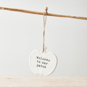 A charming ceramic pumpkin hanger with a stamped 'Welcome to our patch' slogan and jute string hanger. 