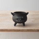 A black ceramic cauldron with "trick or treat" message and double handled design. 
