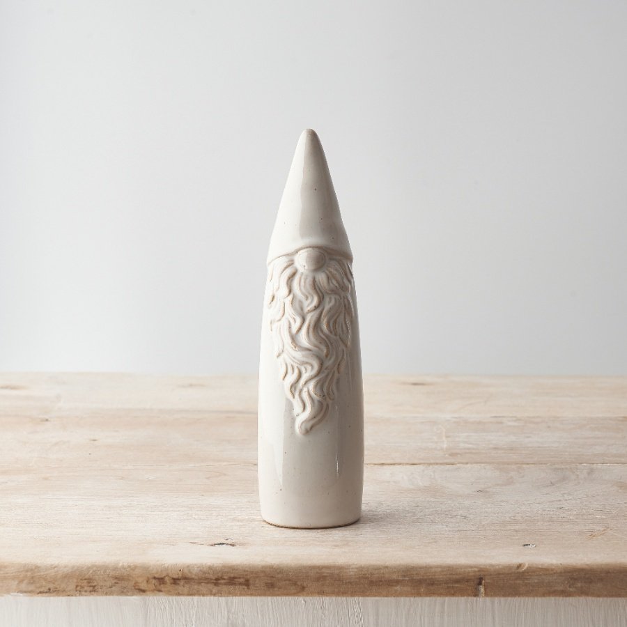 A gonk shaped ceramic ornament with an elongated tall design and curly beard detail. 