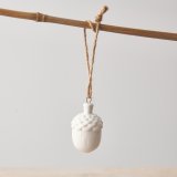 A beautifully simple white acorn decoration. With charming details and a rustic jute string hanger. 