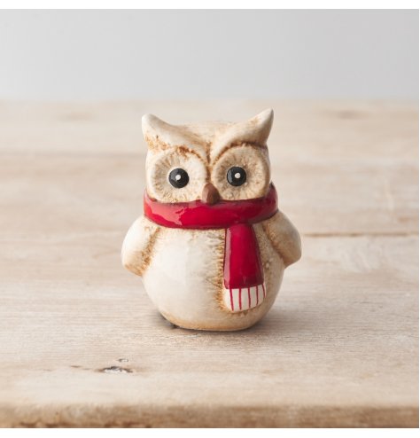 A rustic owl ornament with a red scarf and natural glaze.