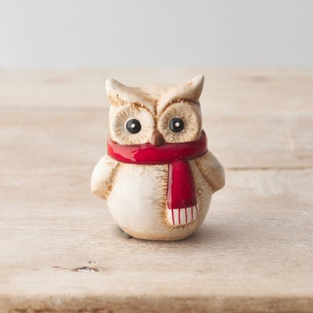 A rustic owl ornament with a natural glaze and ruby red scarf. 