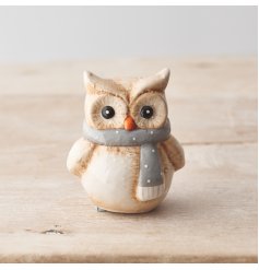 A charming owl ornament with a grey and white polka dot scarf. 