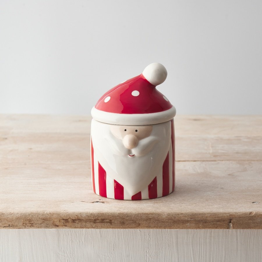 A colourful Christmas storage container with a jolly Santa face, striped body and hat shaped lid.