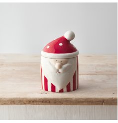 A jolly Father Christmas storage container in red and white festive colours. 