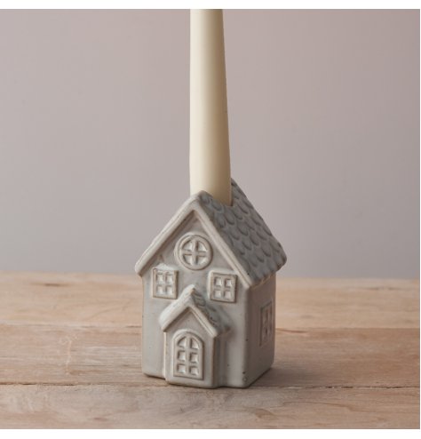 A charming ceramic candle stick holder with a rough luxe natural glaze and rustic details. 