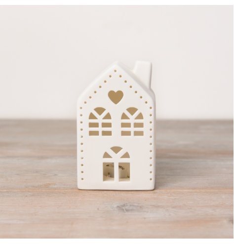 A ceramic house with cut out design, cute heart detail and light up feature. 