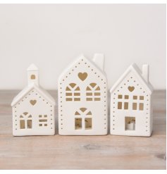 A stylish ceramic house with cut out design, heart details and light up features. 